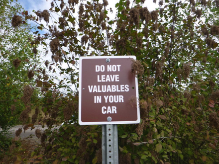 ‘Do not leave valuables in your car’ sign posted in the main parking lot ‘Do not leave valuables in your car’ sign posted in the main parking lot